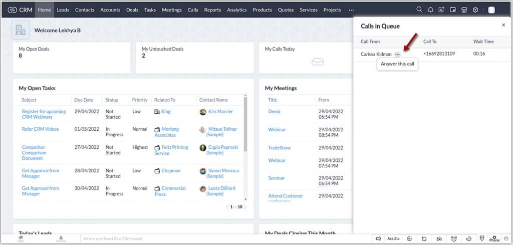 Screenshot of Zoho CRM displaying a call queue panel listing an incoming call with caller details, wait time, and an option to answer the call.