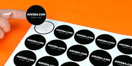 Sticker sheet with black and white stickers featuring a company logo, origin date, and domain.
